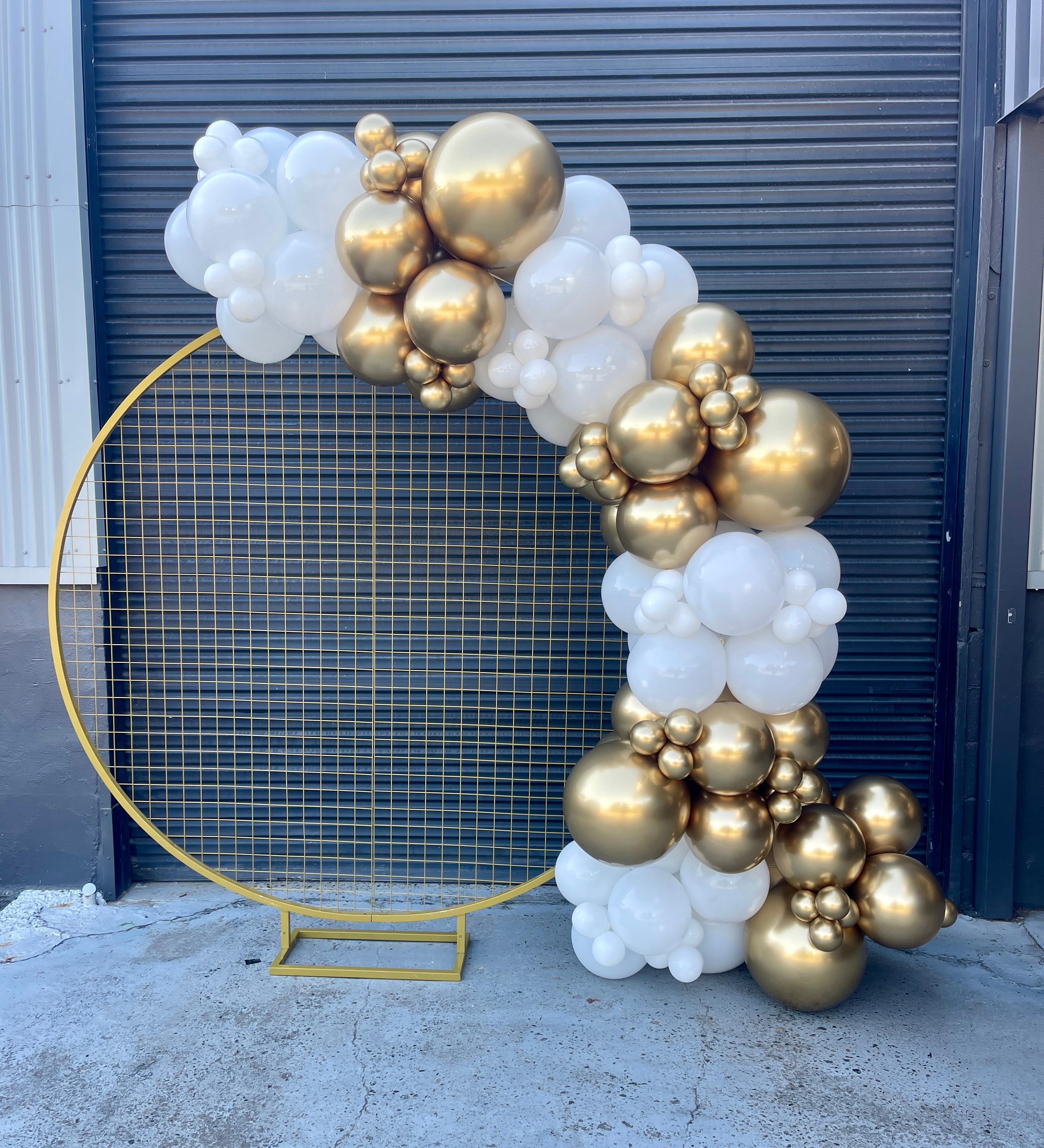 gold and white balloon garland on gold circular mesh stand