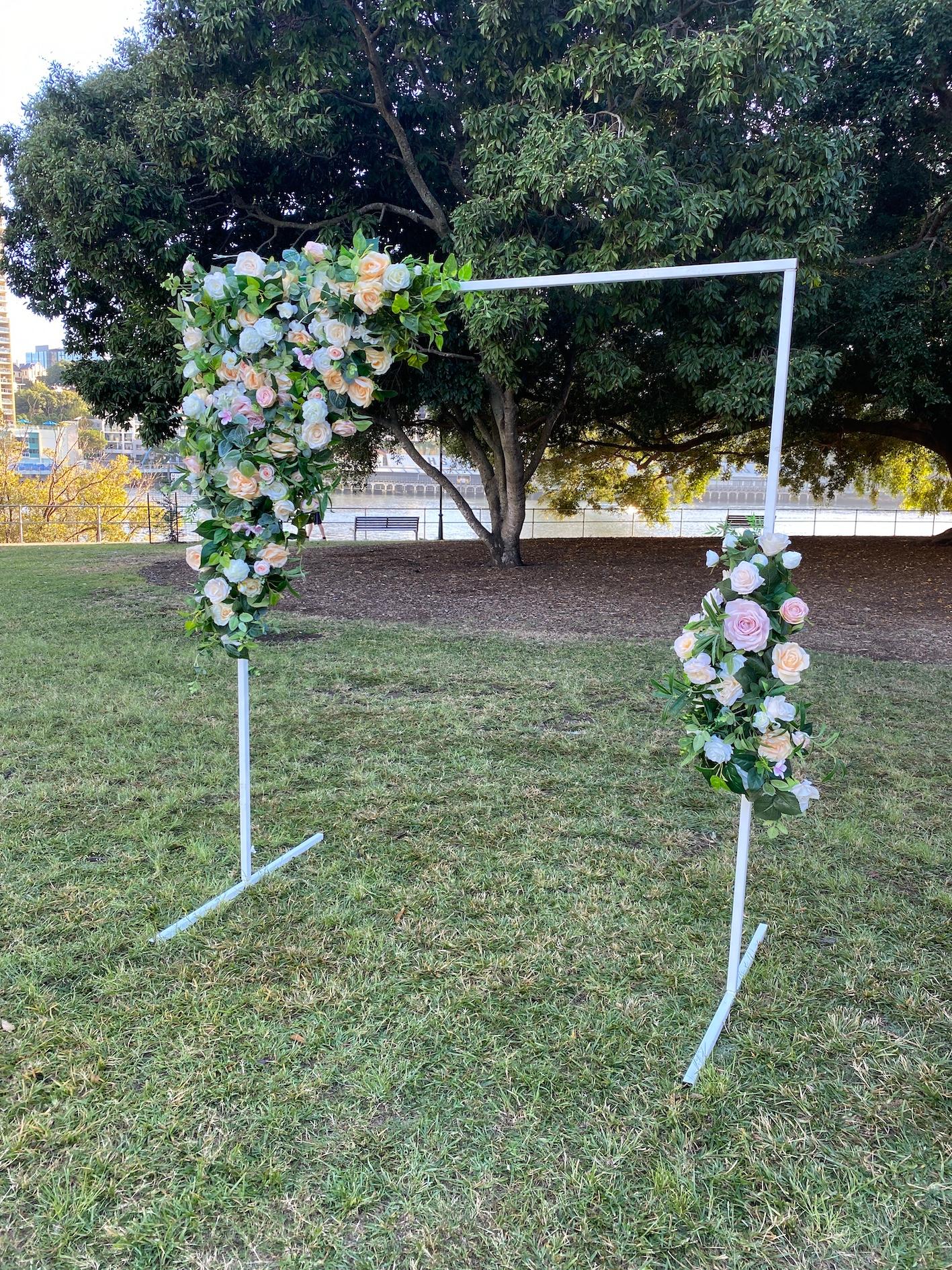 white frame stand with spring flower garland